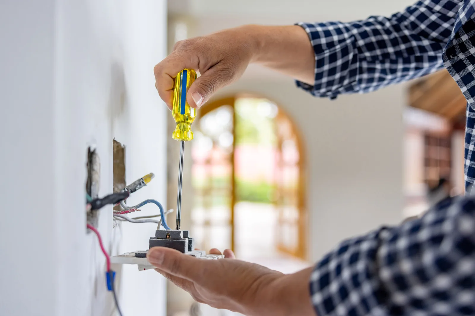 Licensed electrician at work in a local home
